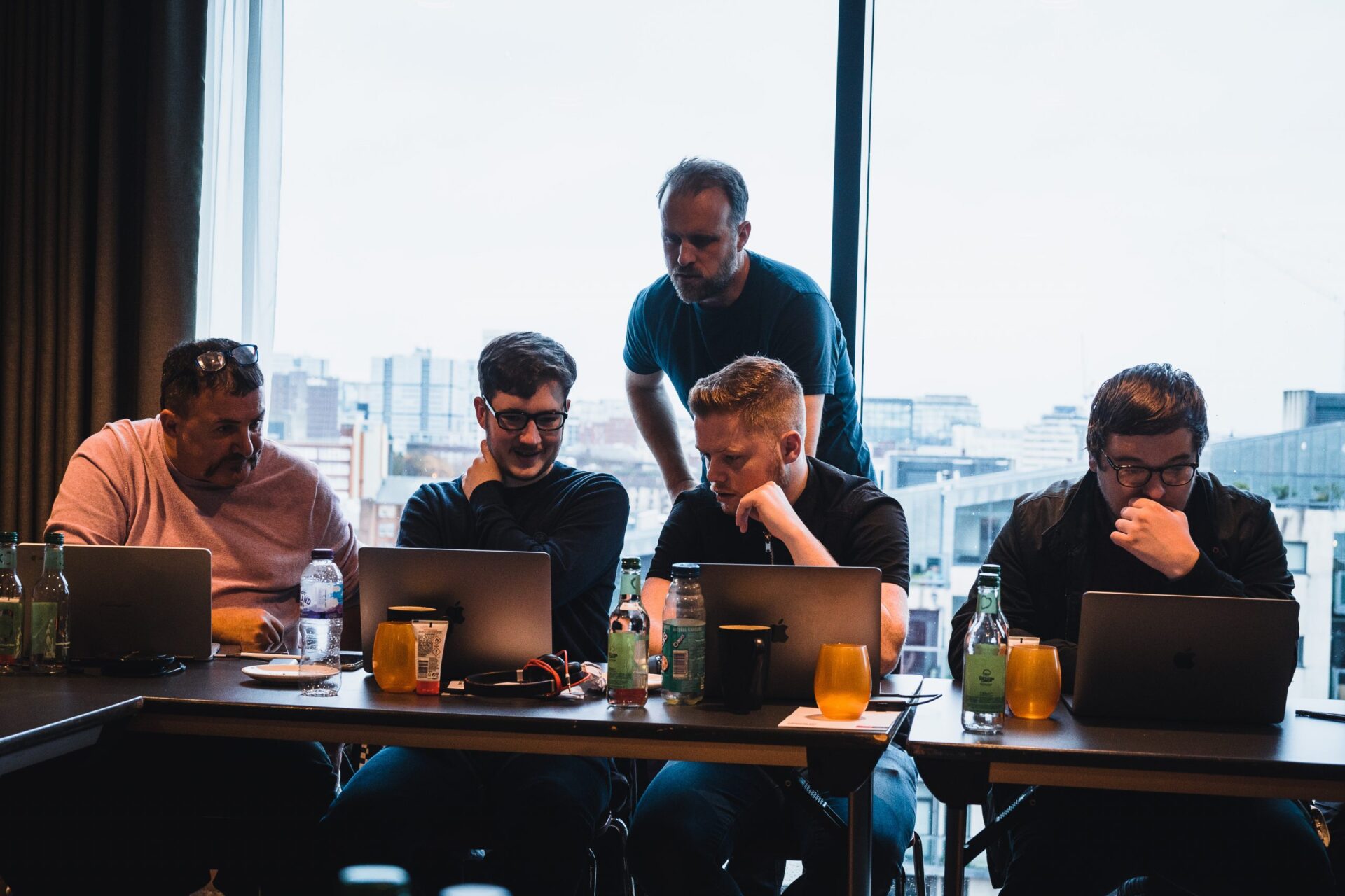 Cobry employees huddled around a laptop.